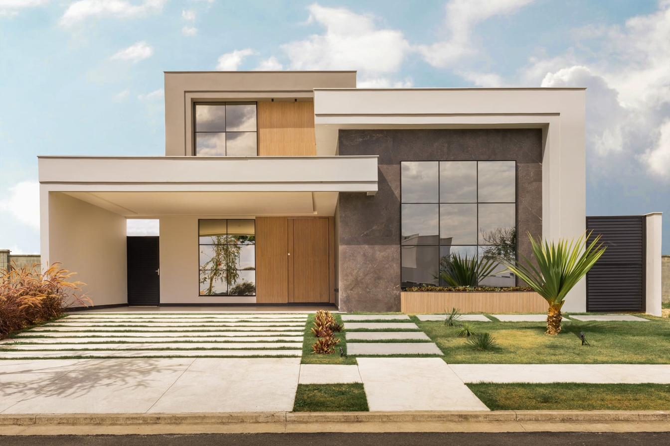 A modern home entrance with a gated driveway